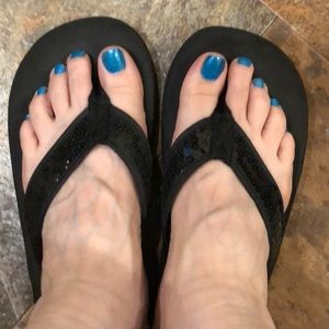 Black sequined flip flops.